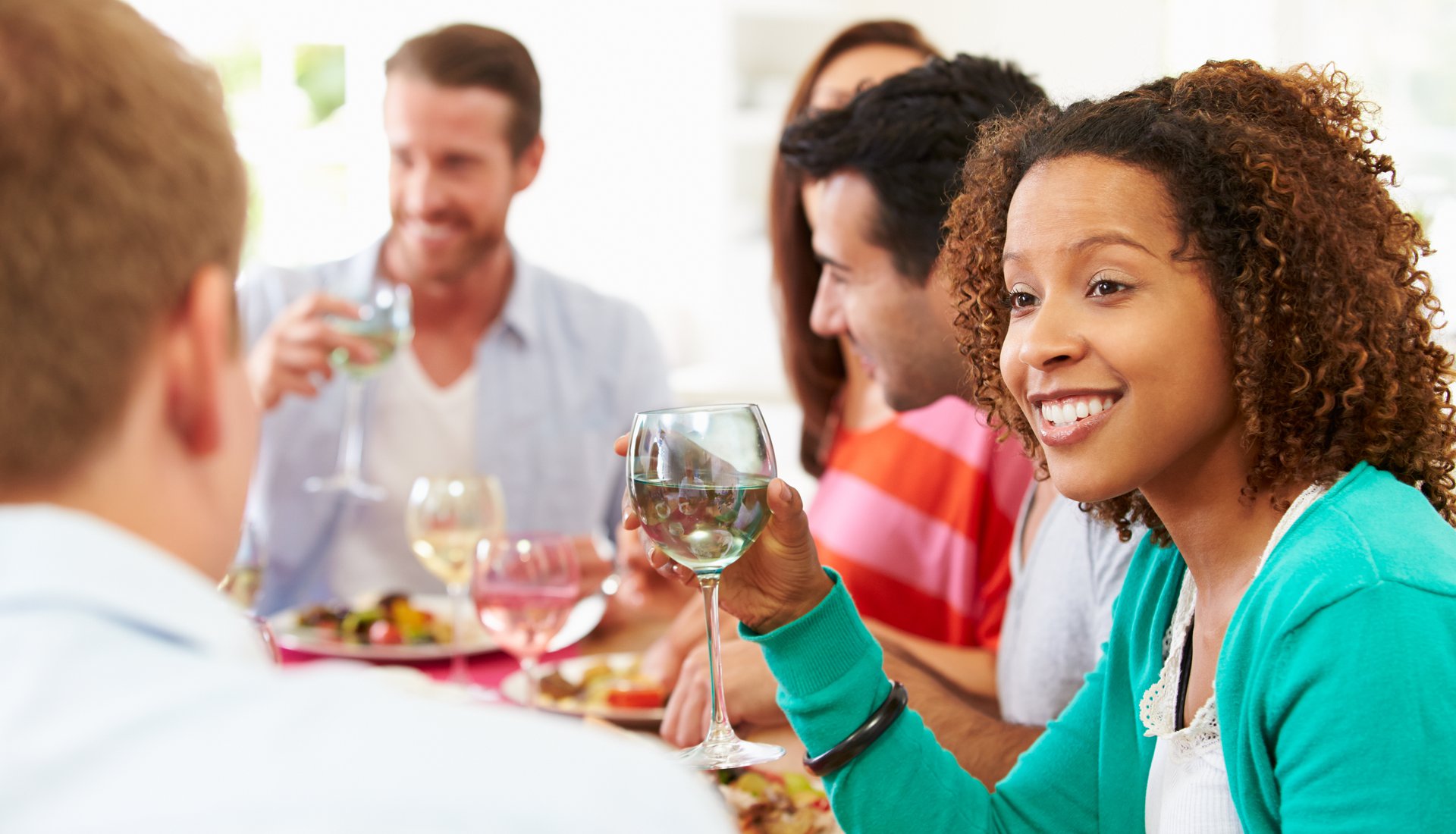 Group Of Friends Sitting Around Table Having Dinner Party